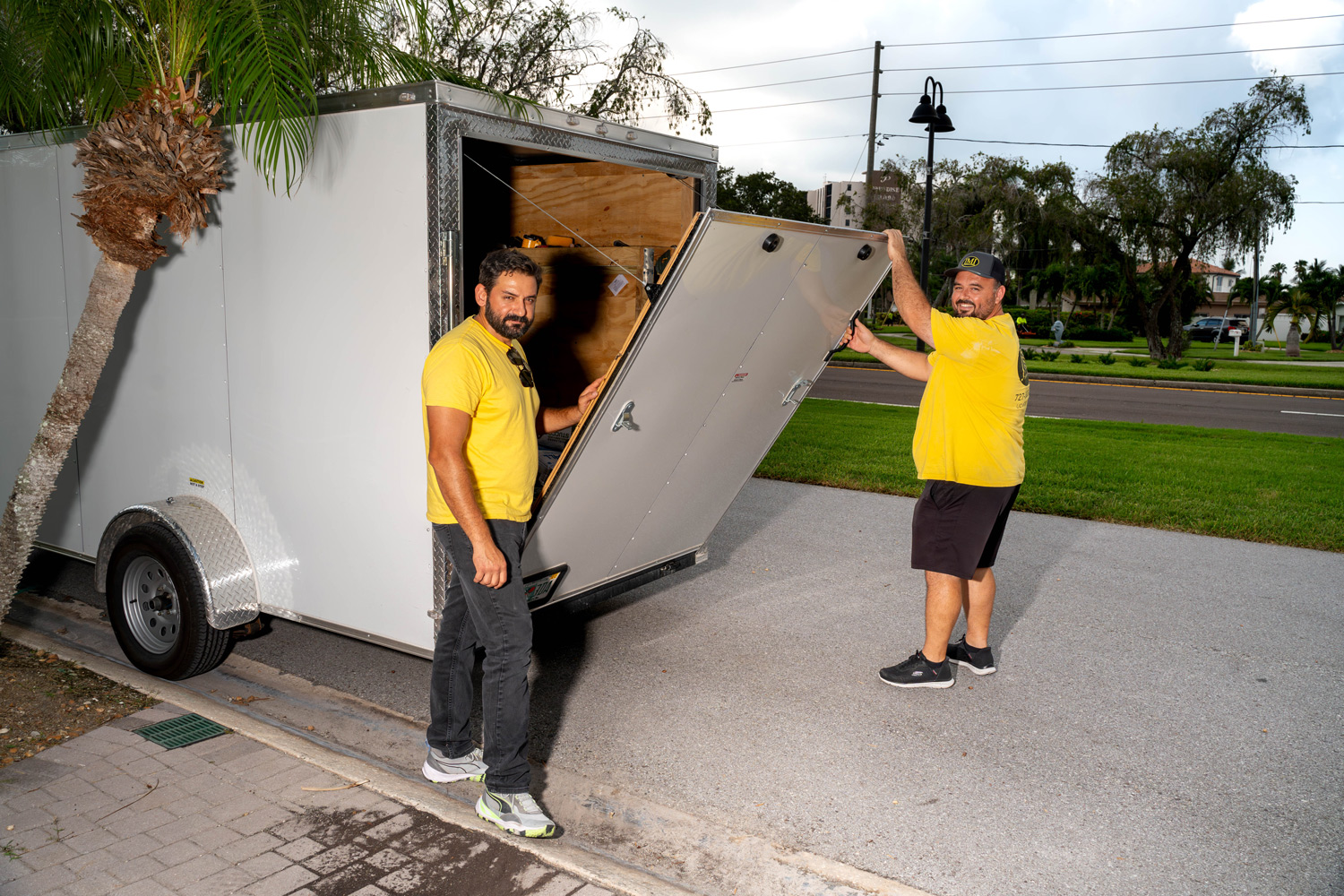 JMI Windows & Doors team unloading tools from a trailer, preparing for a professional sliding glass door installation.