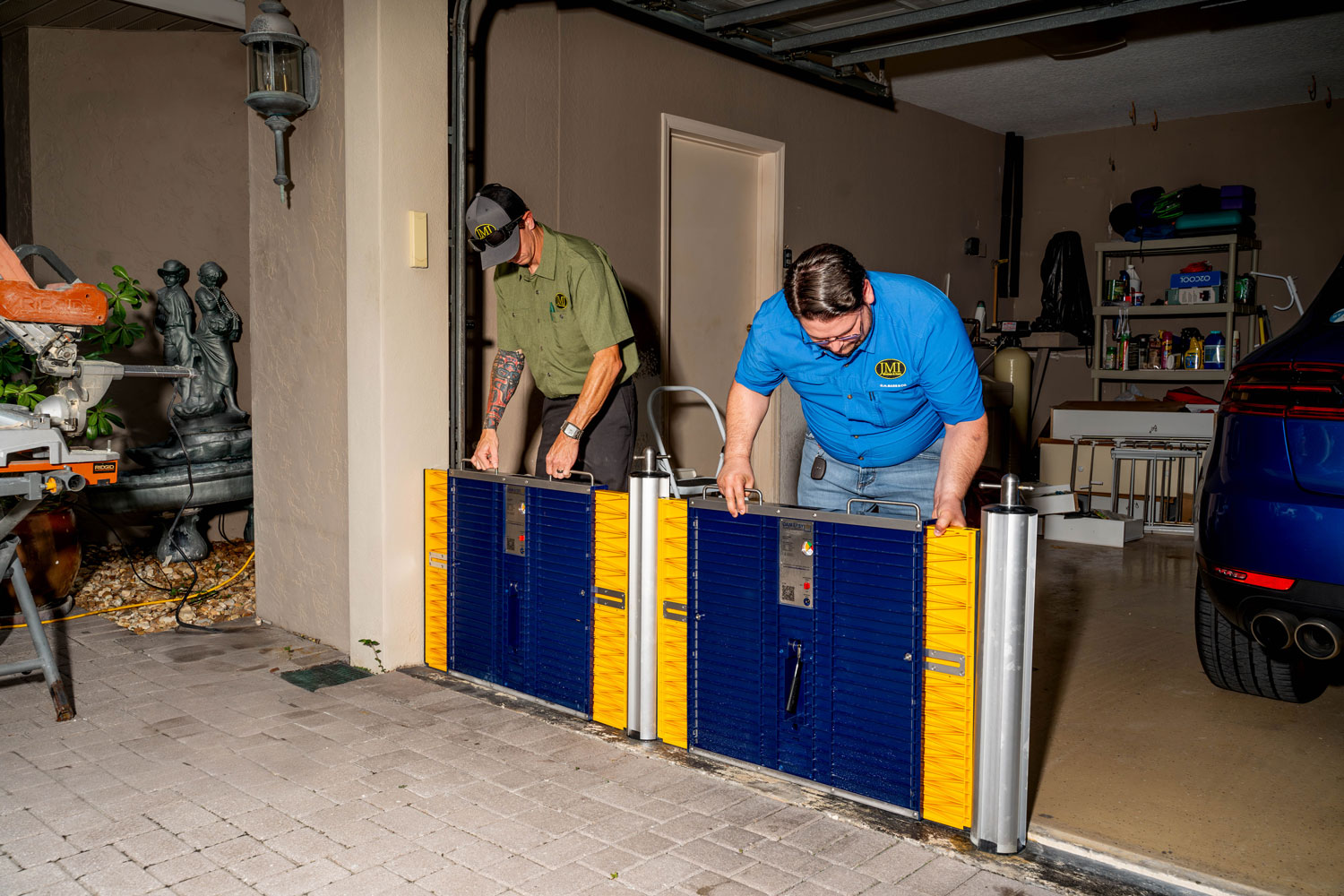 JMI Windows & Doors expert installing flood barriers for a homeowner’s garage.